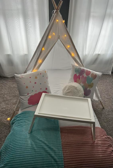 Colorful sleepover tent setup with tray and pillows
